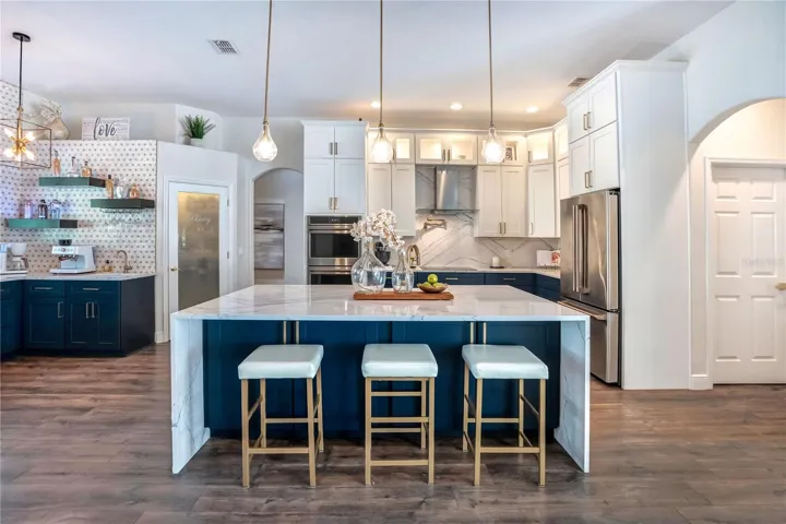 Navy island with Cambria waterfall top and seating for 3.