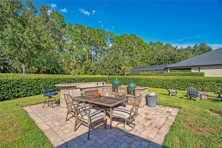 Outdoor kitchen with stone bar and dining patio.