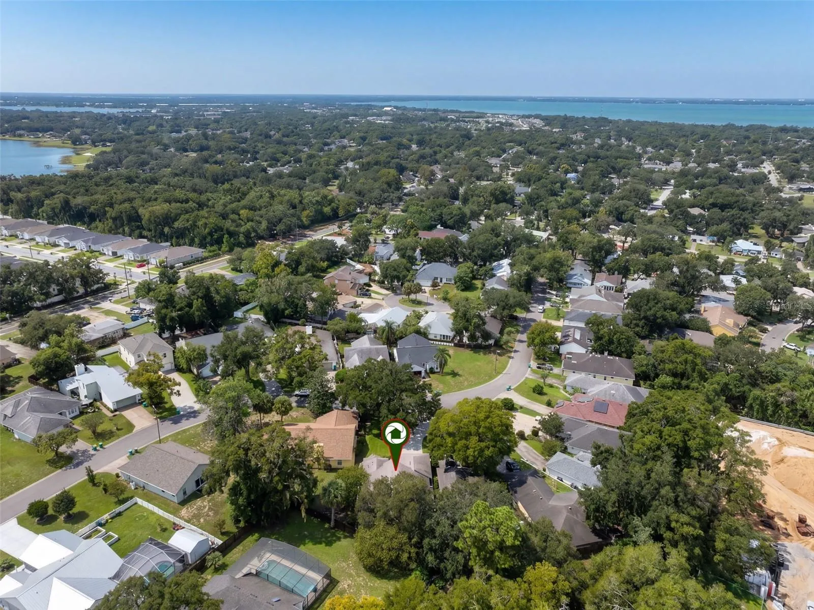 A wider aerial view places the home within the neighborhood.
