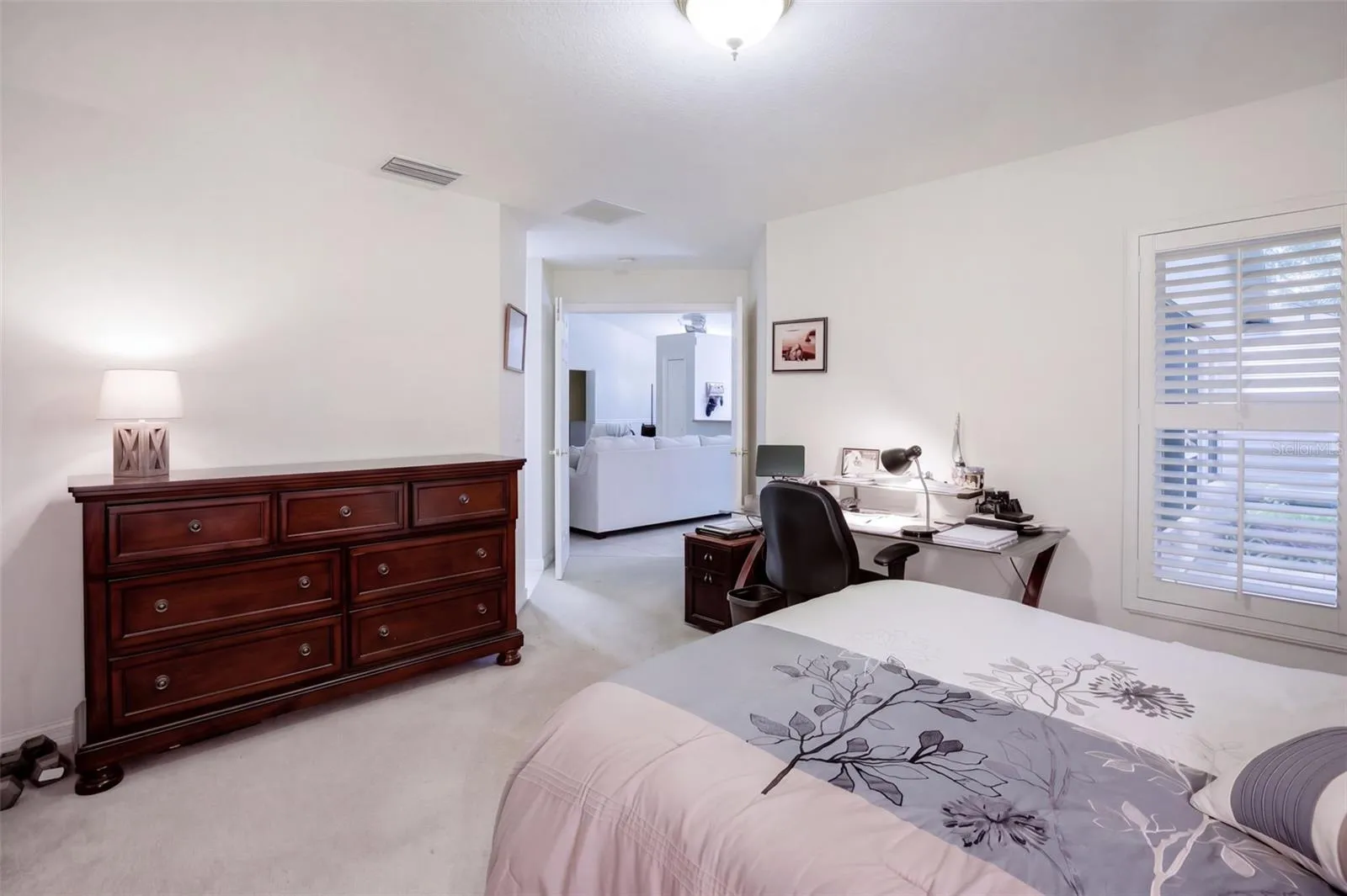 The guest bedroom offers convenient access to the hall and secondary bath.