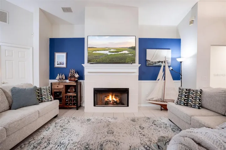Vaulted ceilings and a wood-burning fireplace create a memorable centerpiece in the main living room.