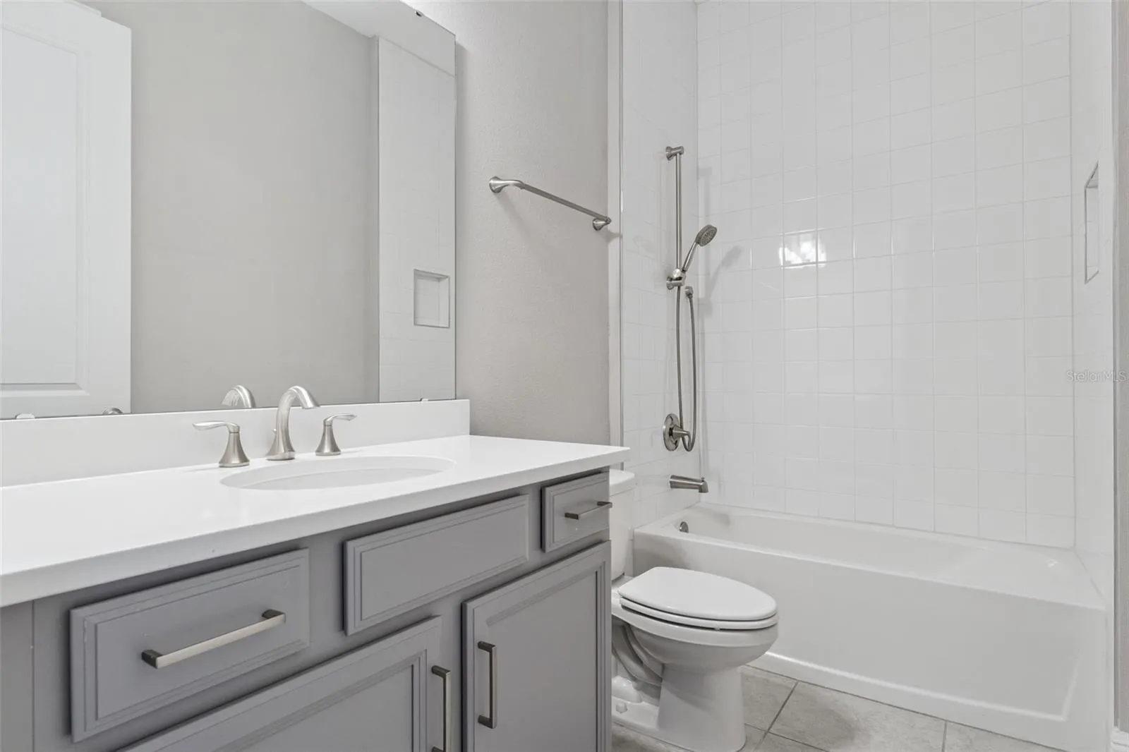 Additional full bathroom with modern finishes and tub/shower combination.
