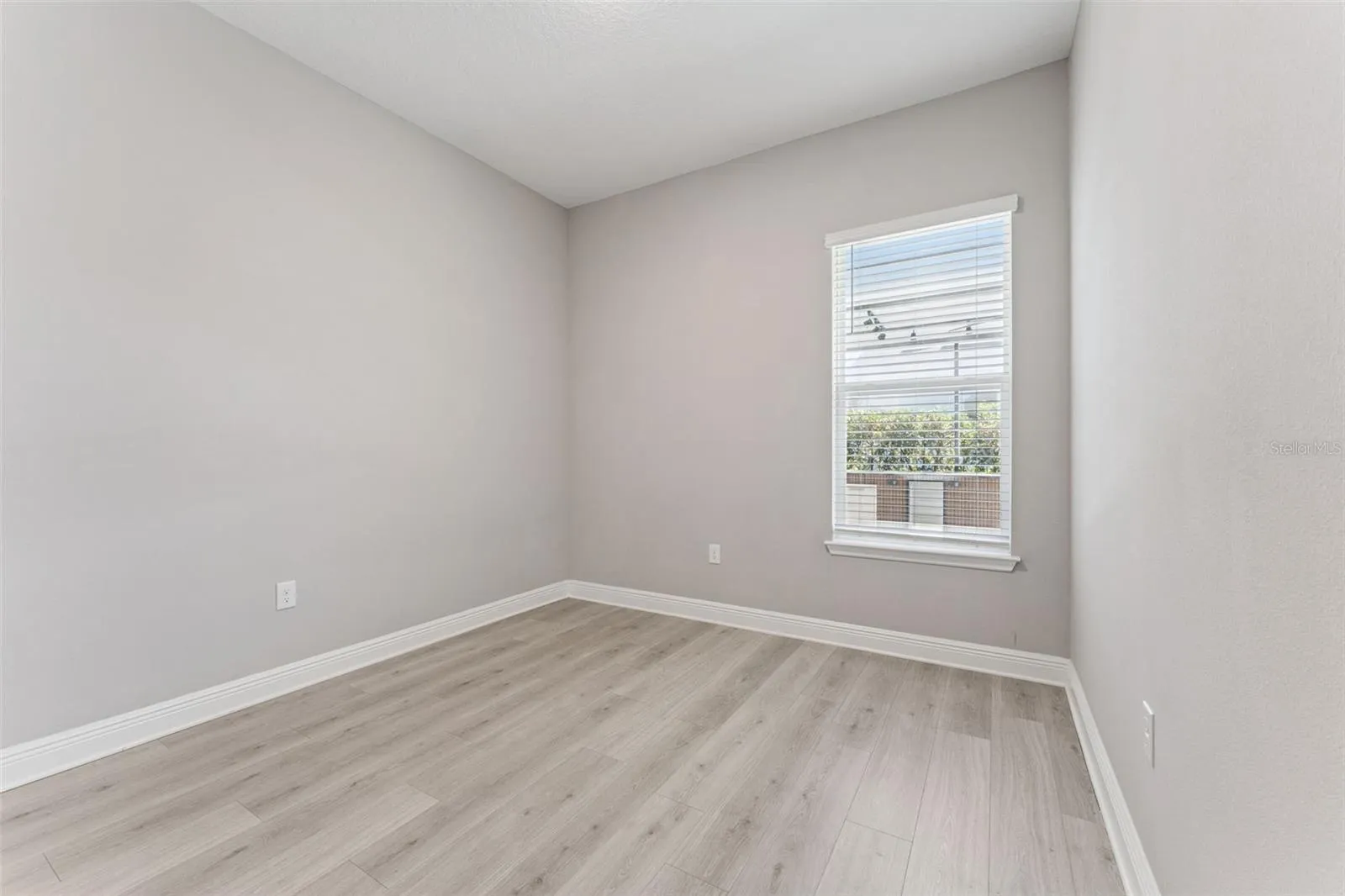 Versatile secondary bedroom with plenty of space for a home office, gym, or playroom.