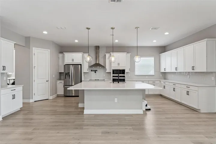 Bright kitchen featuring a large island and open-concept layout.