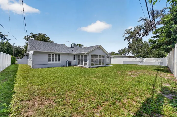 Rear Exterior — Generous fenced backyard with open lawn and plenty of room for outdoor enjoyment.