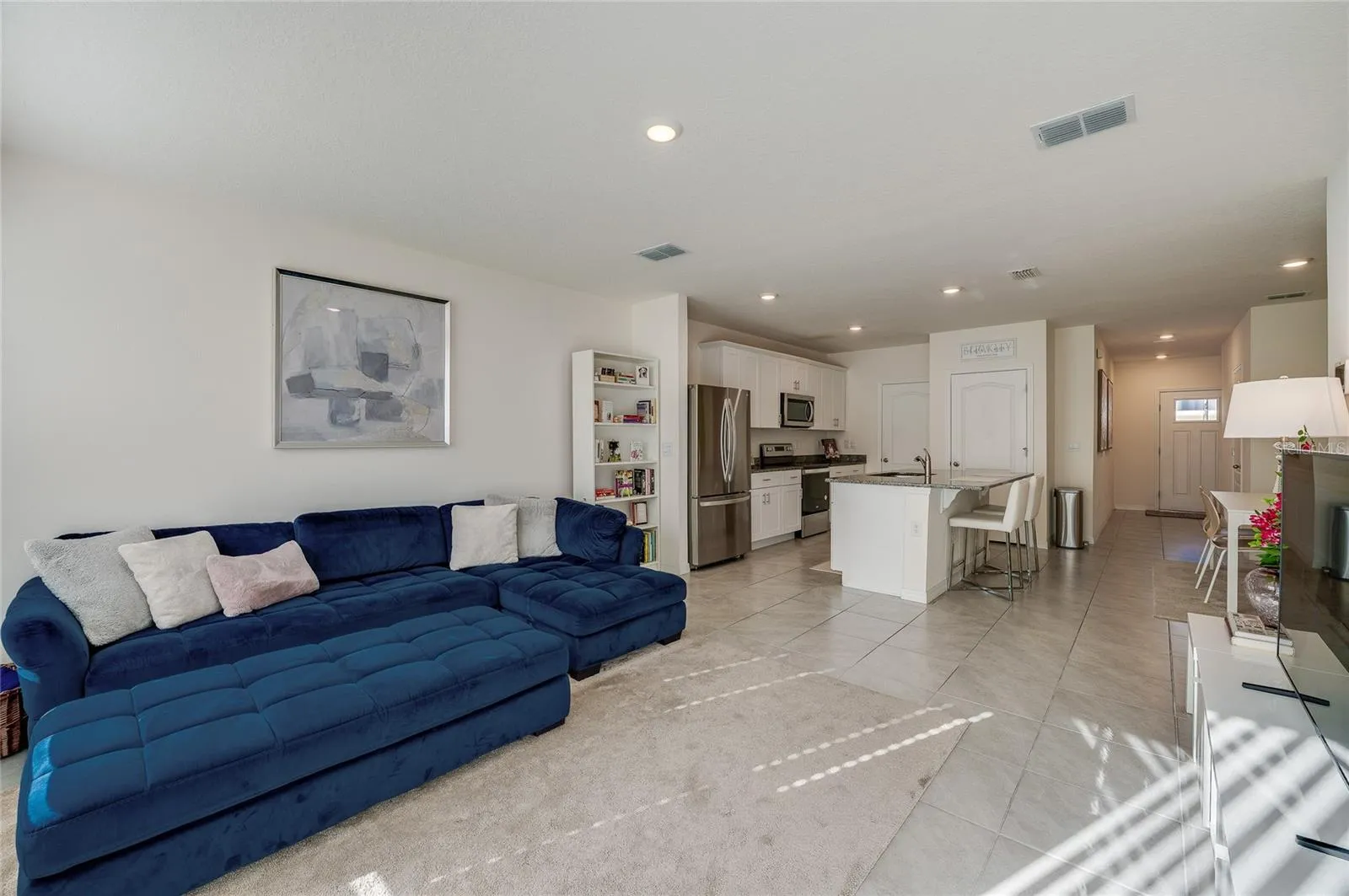Spacious living room offers plenty of room for comfortable seating while maintaining an open connection to the kitchen and dining spaces.