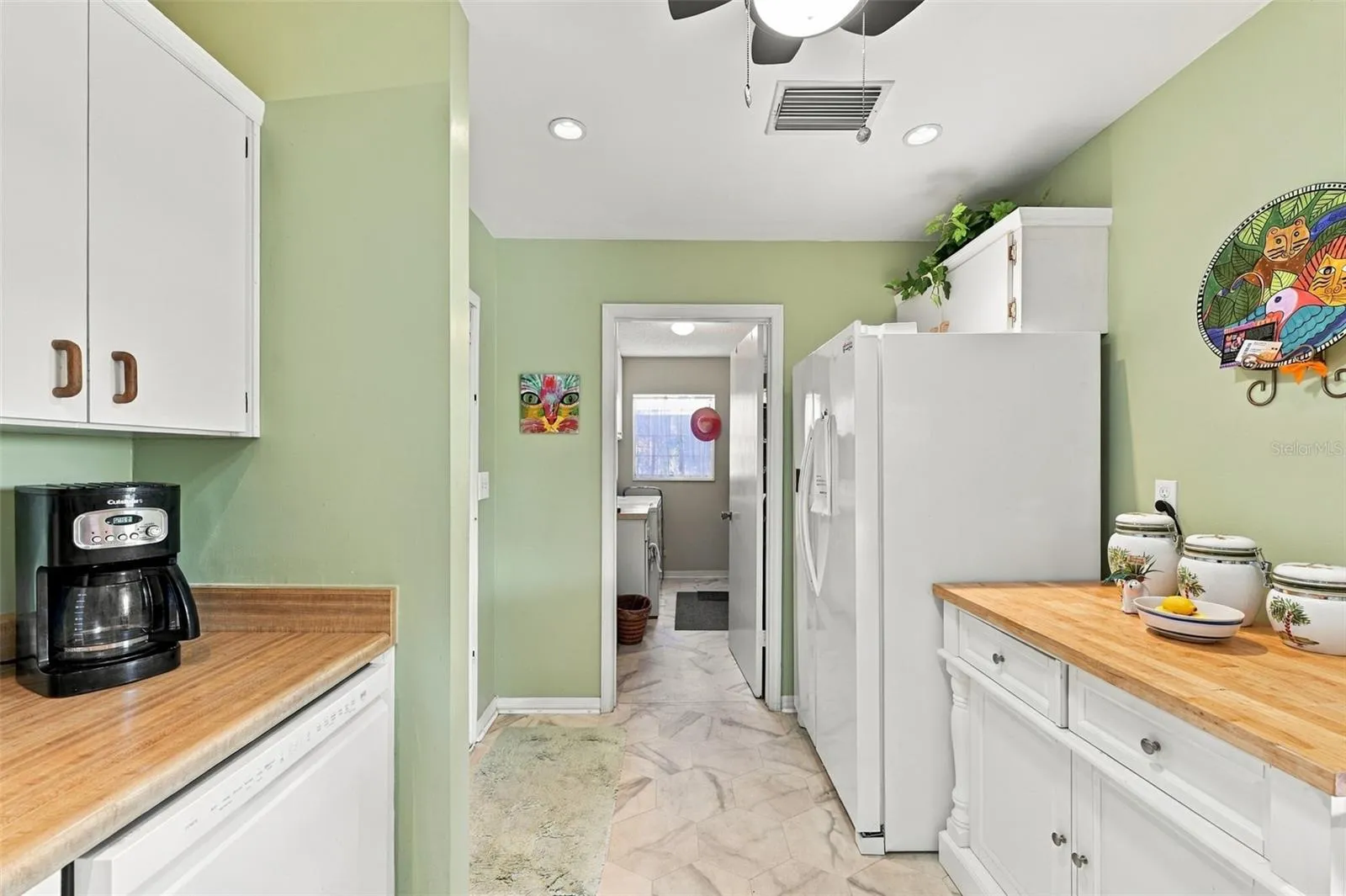 The kitchen feeds right into the inside laundry/storage room.