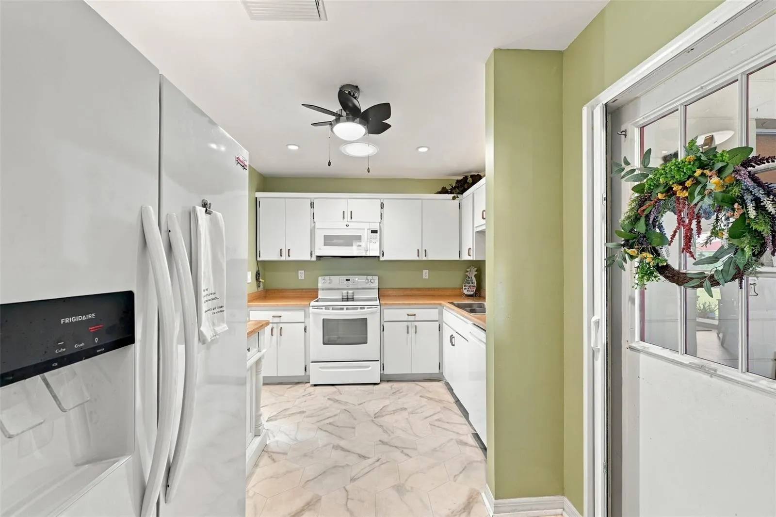 The kitchen is a very nice size and the door to the garage has a screen door attachment, so that you can open the garage door and let the sea breezes blow through the home.