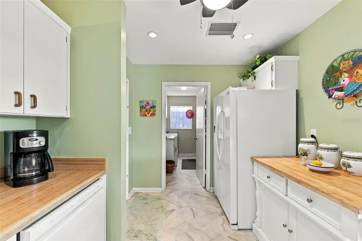 The kitchen feeds right into the inside laundry/storage room.