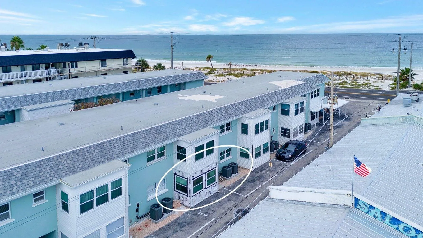 Condo Building with parking space behind.