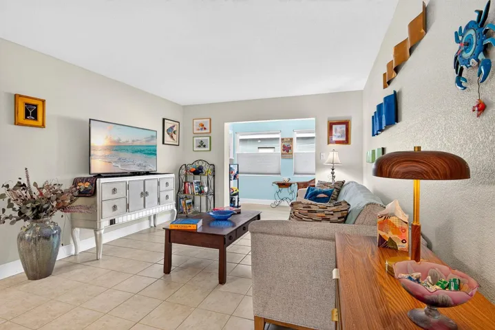Living area facing back enclosed sunroom