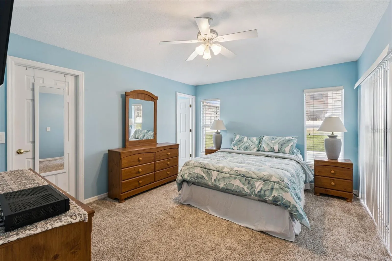 primary bedroom with sliders to pool and patio area