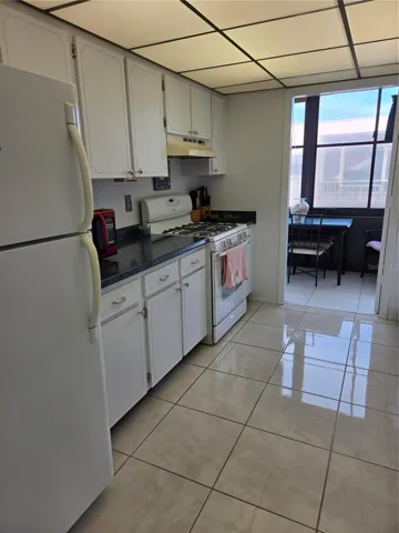 Lots of cabinets in the spacious kitchen