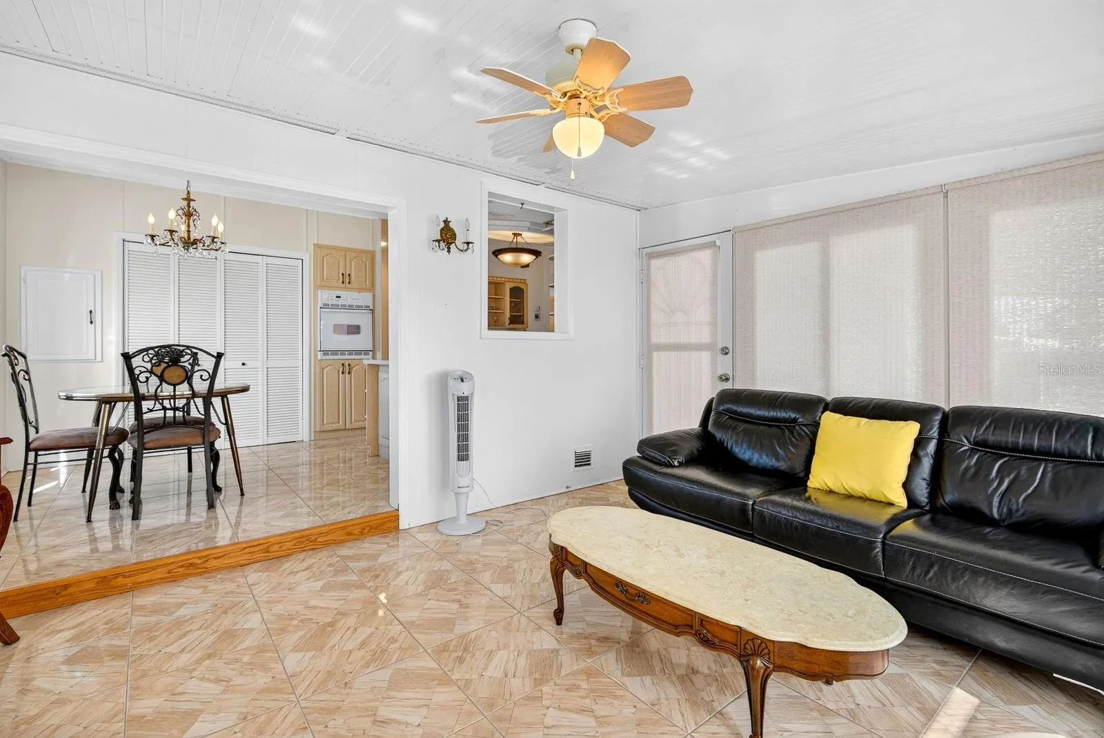 Enclosed Sunroom with breakfast area/kitchen behind it