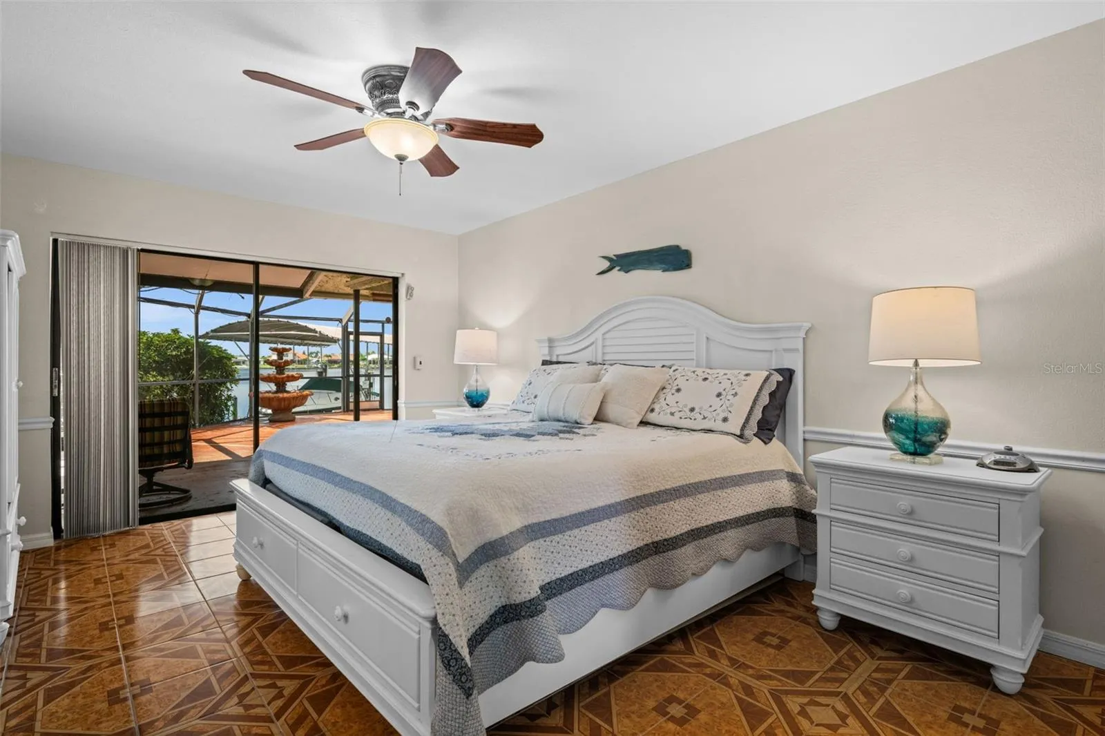 Primary bedroom opens toward the waterfront outdoor area