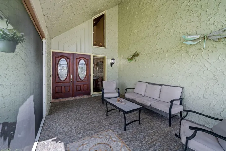 Big sitting area in the screen porch before you enter
