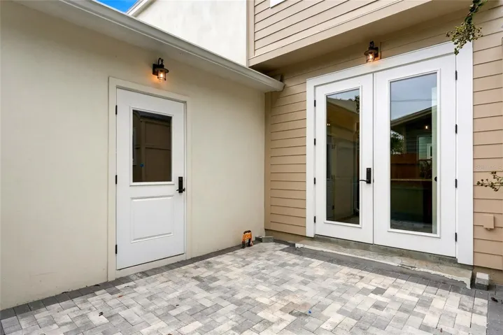 1st Floor Private Patio with Garage Access and Double Doors to Kitchen