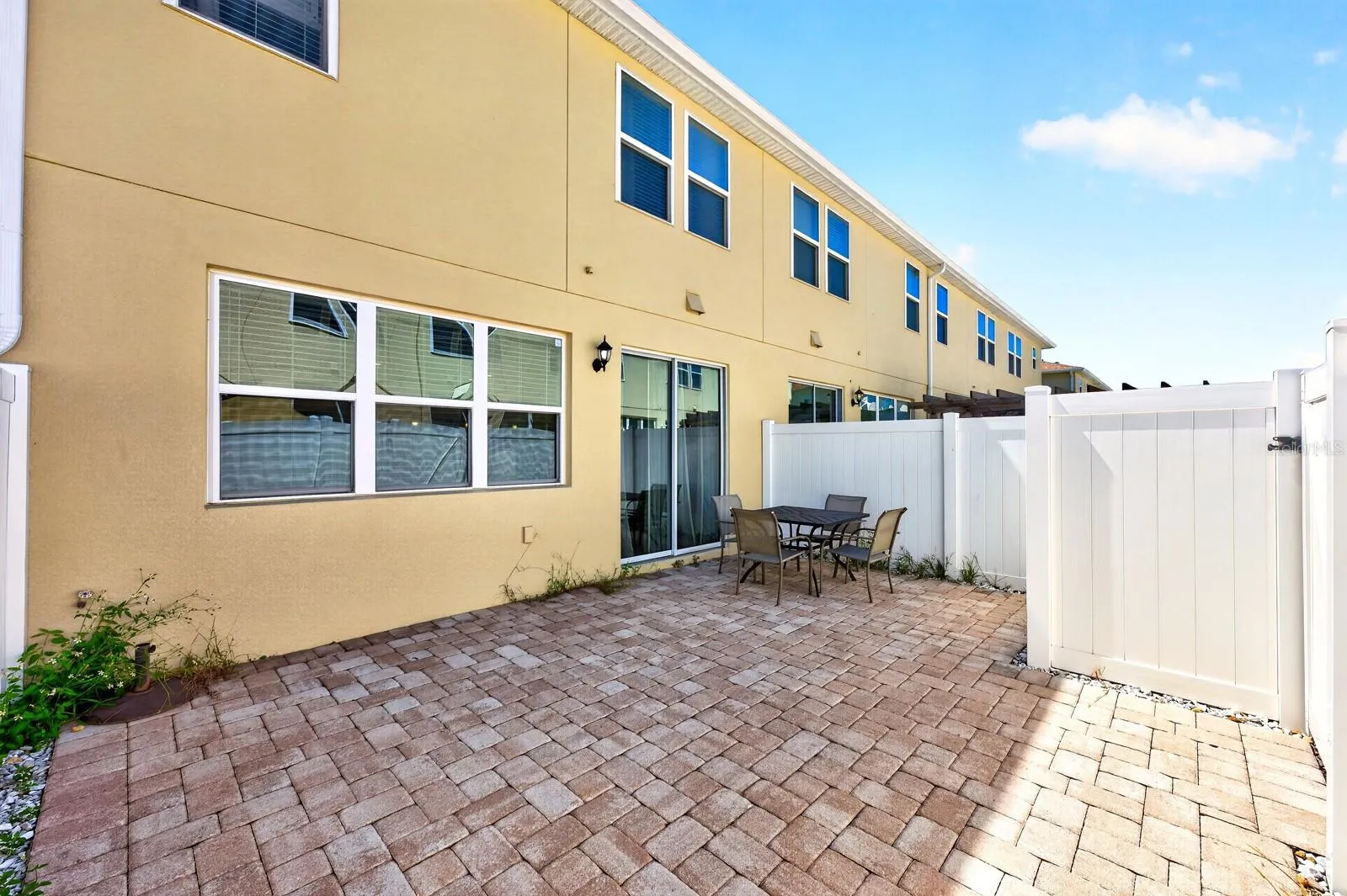 Large privacy fenced paver patio.