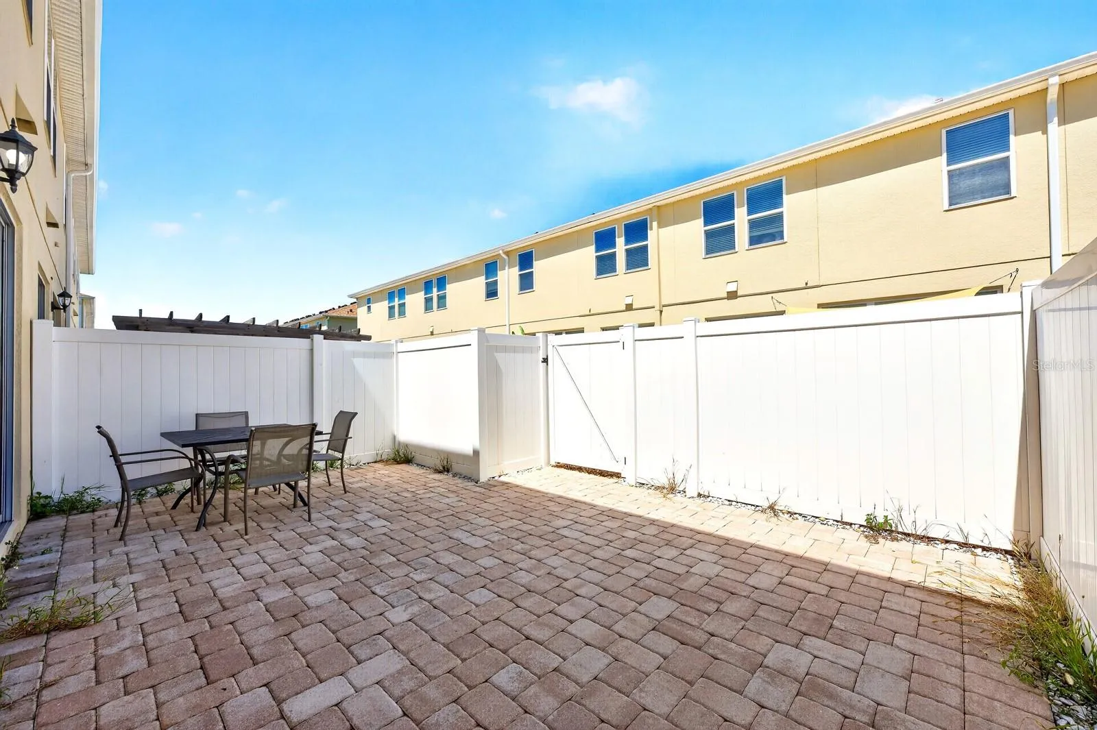 Large privacy fenced paver patio.