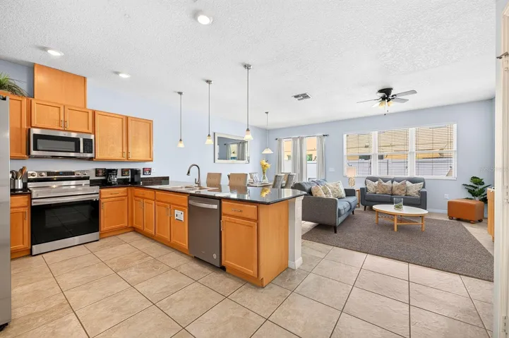 The kitchen is open to the living and dining areas.