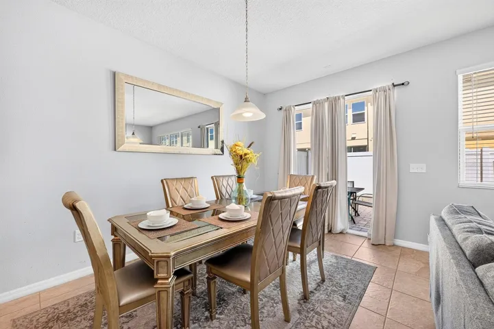 Dining area has sliding glass doors that open to the paver patio.