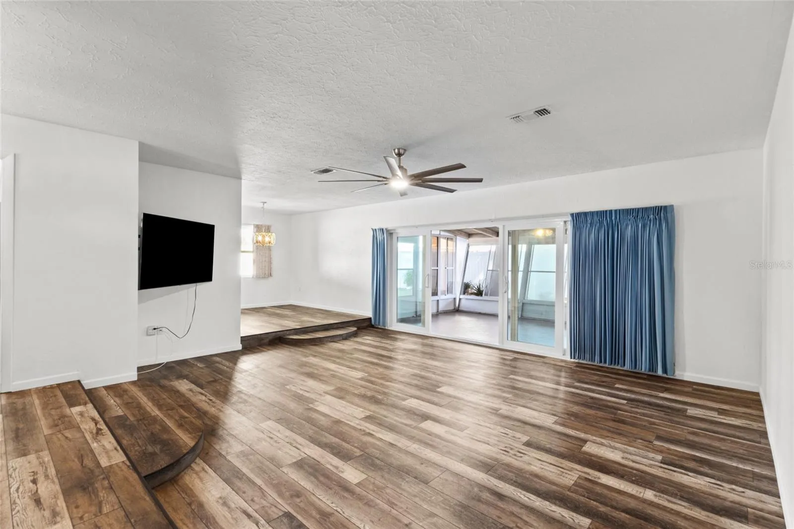 Living room facing the dining area. New sliders out to the FL Room.