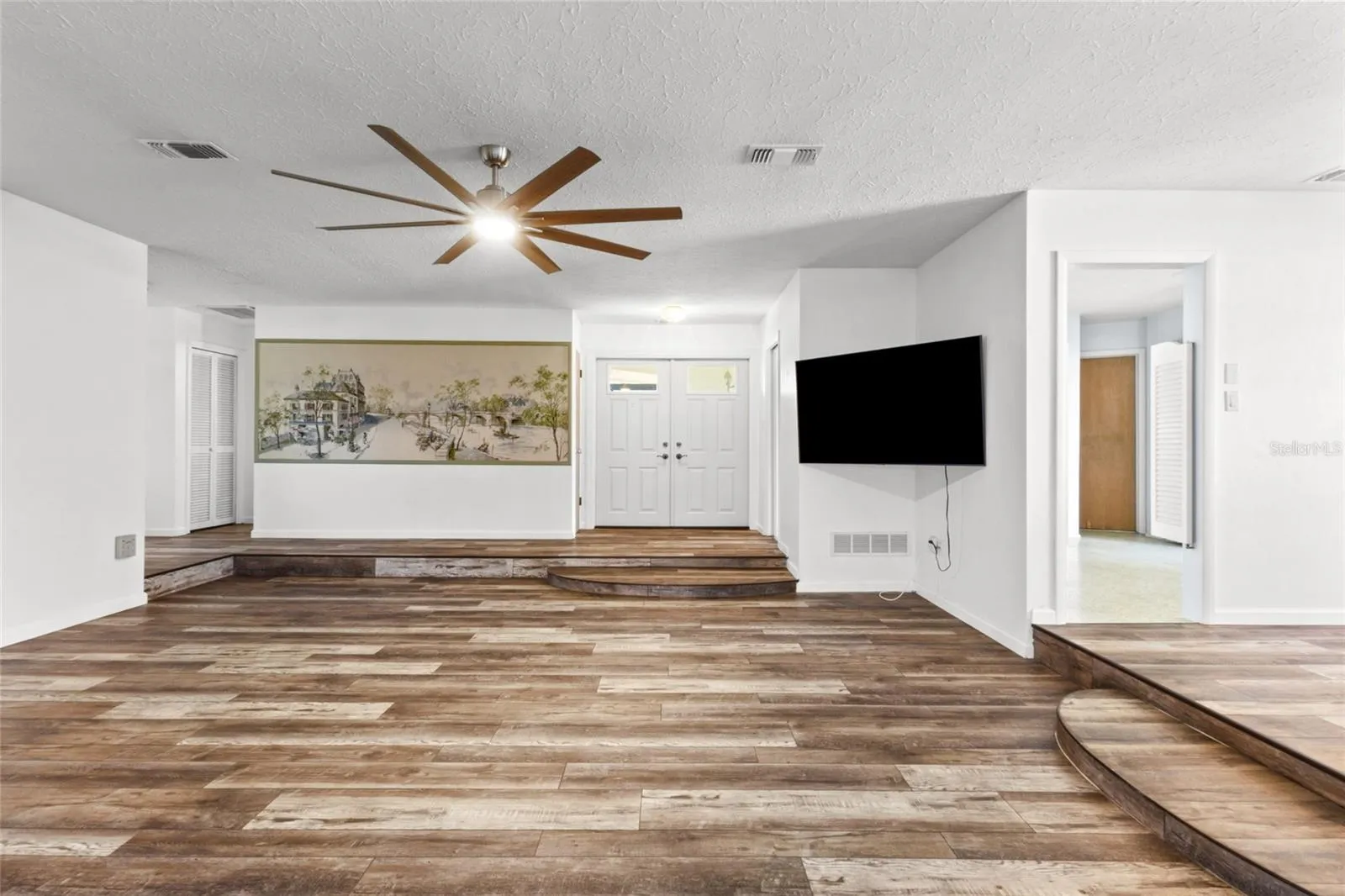 Dining area and kitchen to the right and 2 bedrooms to the left.