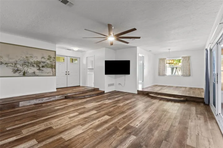 Living room/dining area. Entry way and doorway to the kitchen is on the left.