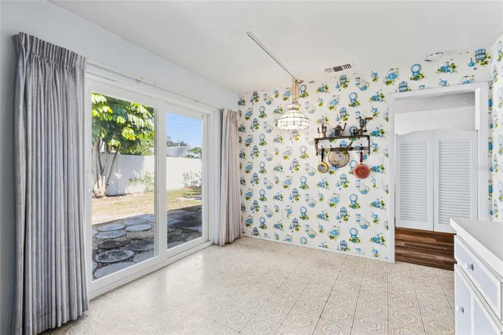 Eat-in area in the kitchen with sliders out to the patio and doors to the dining area.