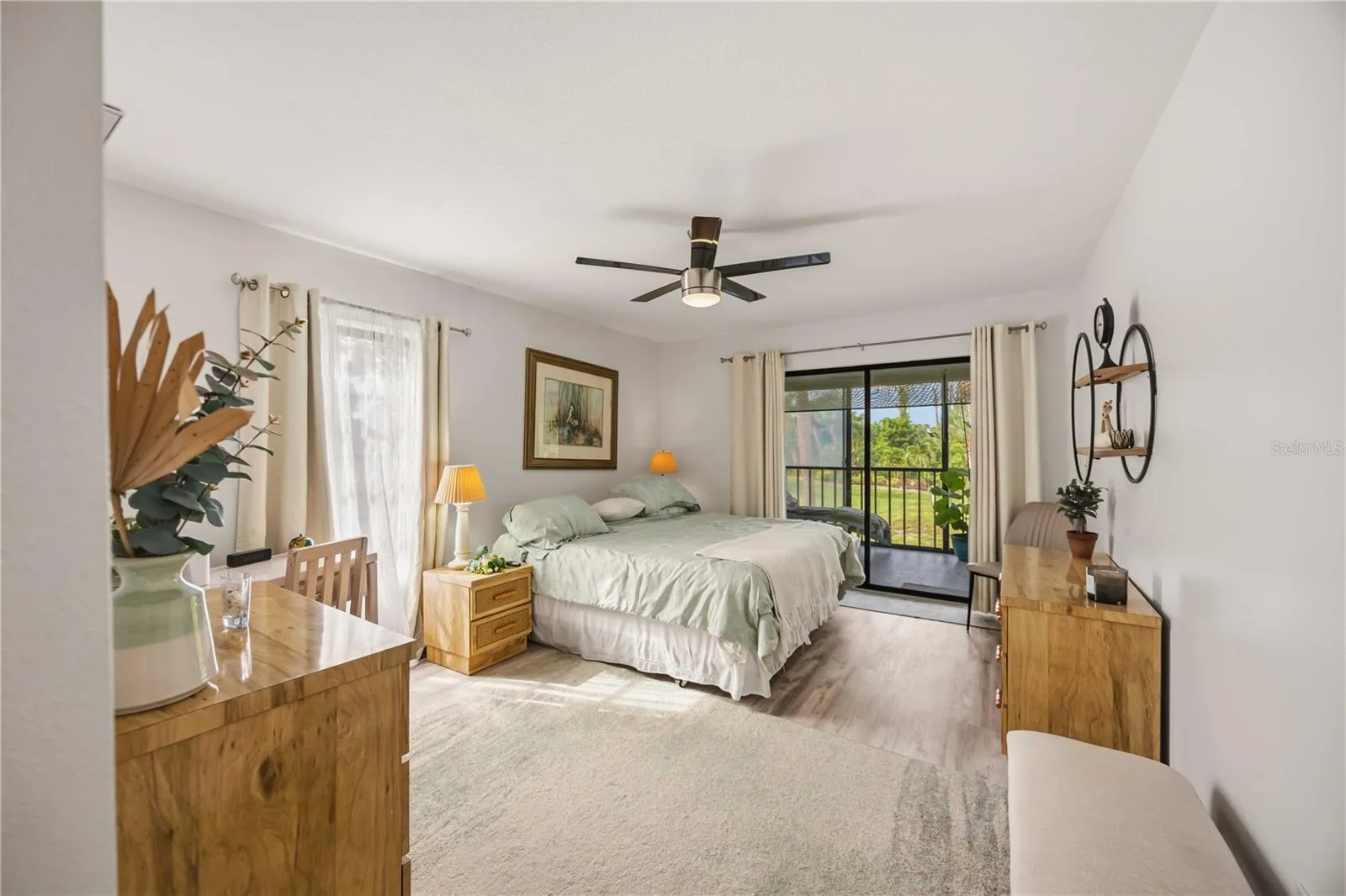large primary bedroom with access to the balcony