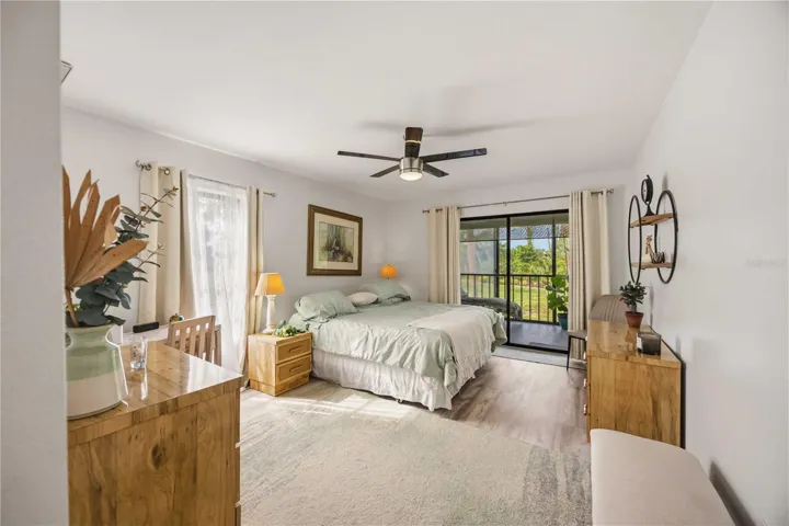 large primary bedroom with access to the balcony