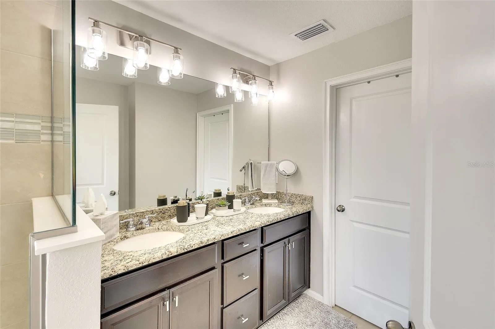 Primary bath (ensuite) with large walk-in closet behind that door!