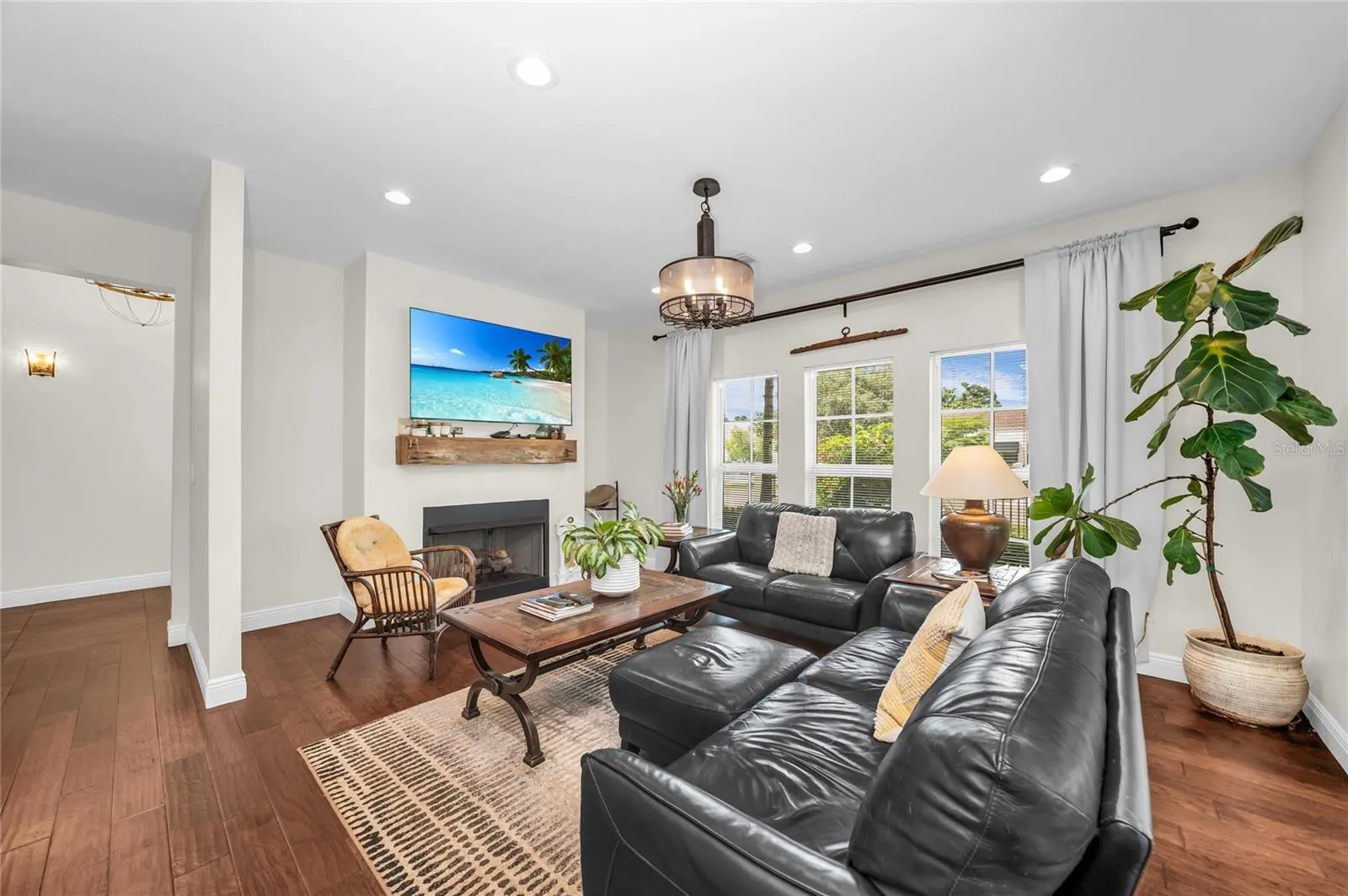 The light filled family room featuring a vent-free gas log fireplace.