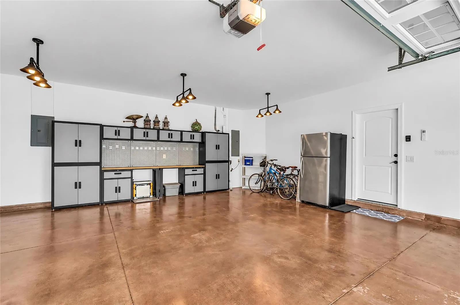 Spacious garage with epoxy floor and custom workbench