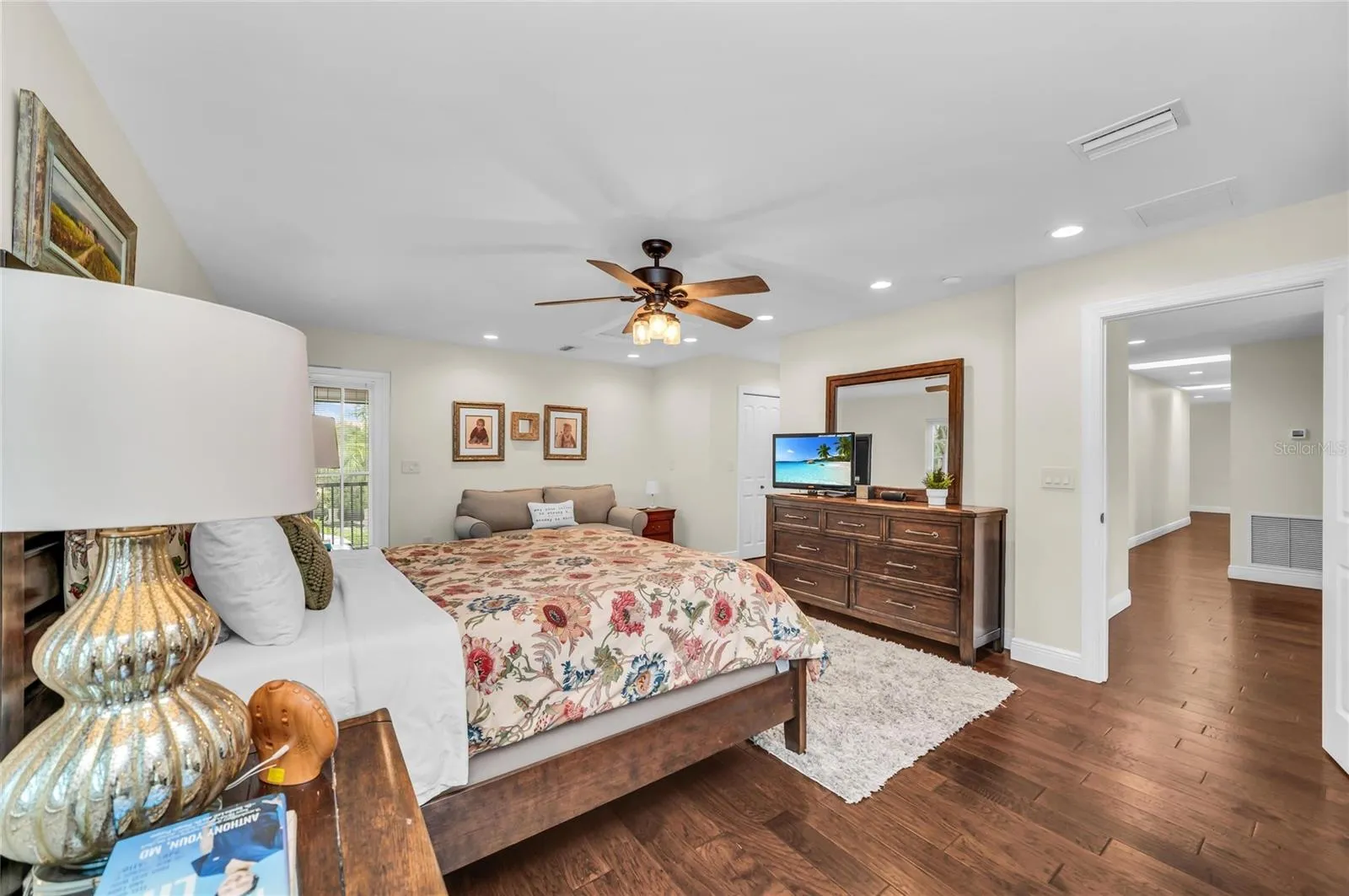 PRIVATE OWNER'S RETREAT featuring a screened porch overlooking the pool and an ensuite bathroom with tub and shower. An additional outdoor shower, accessed from within the full bath brings a touch of resort-style living to the home.