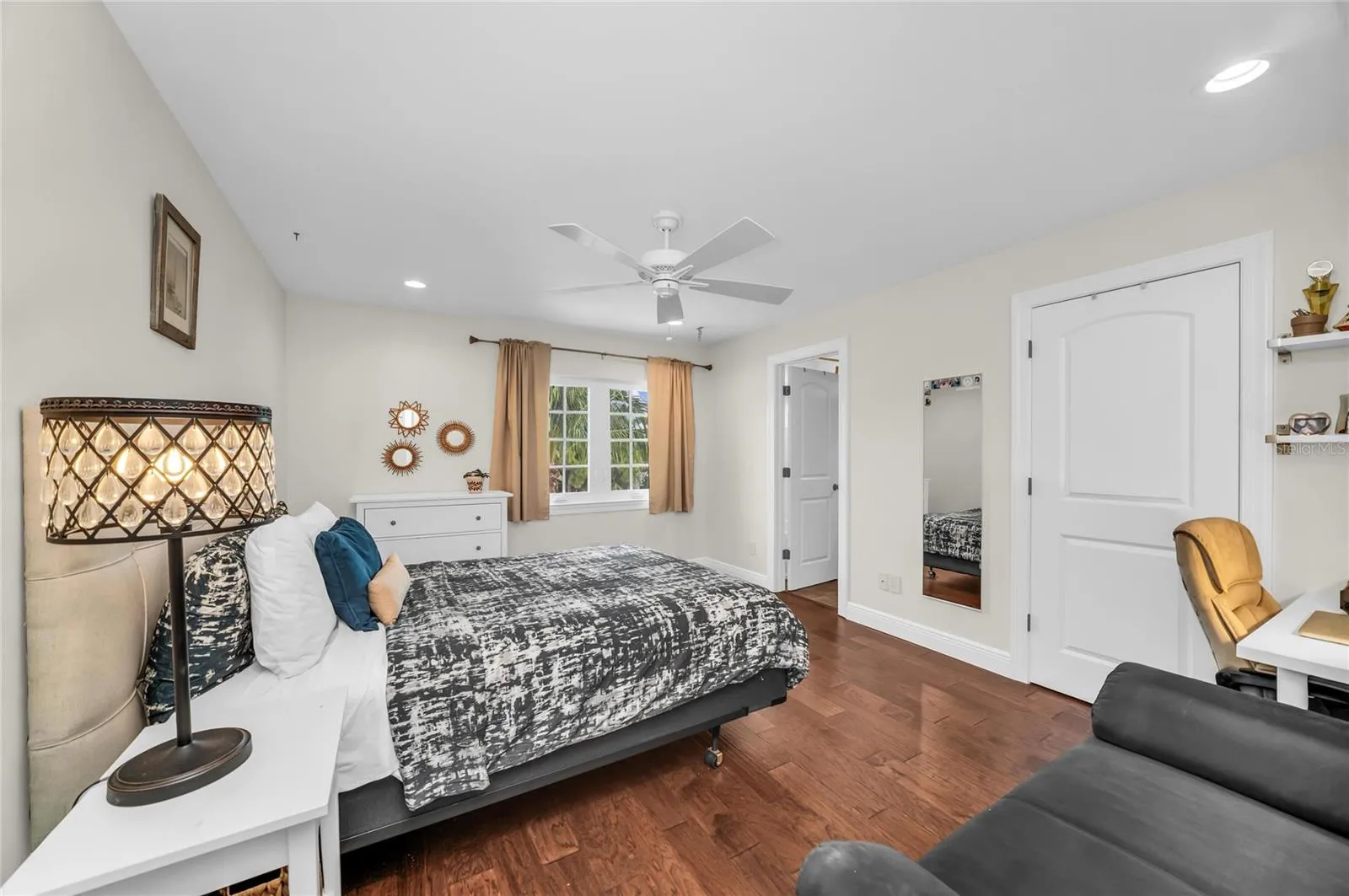 Spacious second level bedroom with an ensuite bath, walk-in closet and view of the pool.