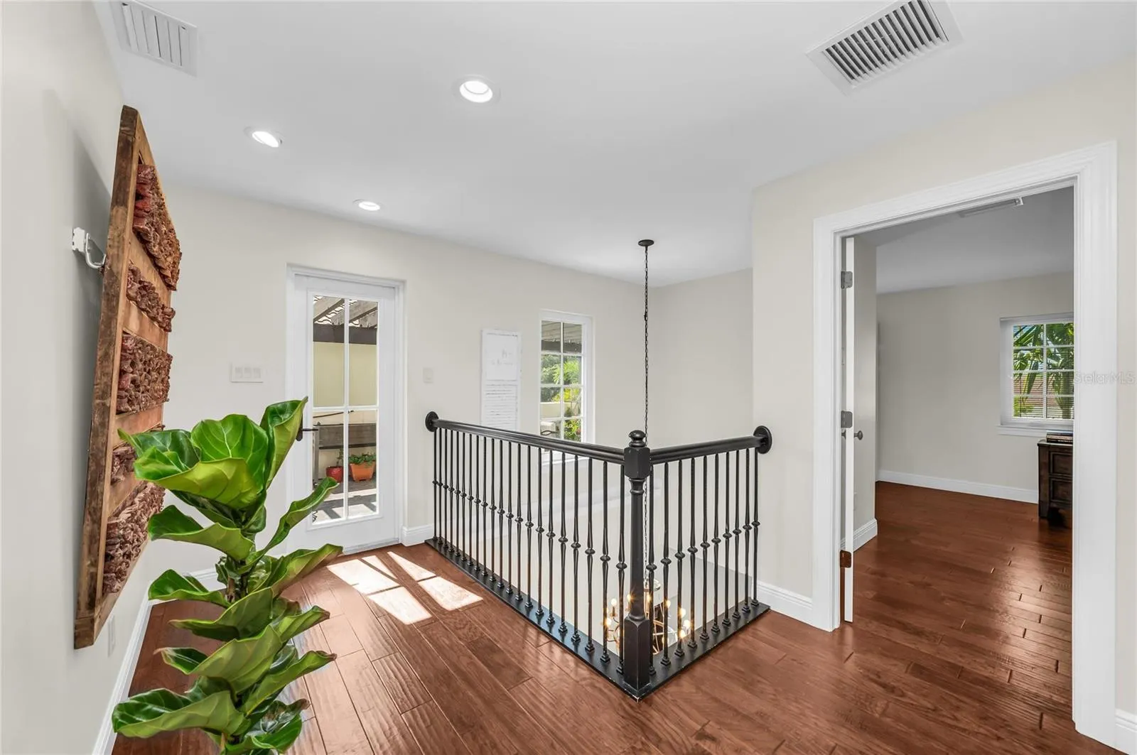 The beautiful upper-level overlook that's seen from the entry foyer below. The glass door seen here leads to the garden deck.