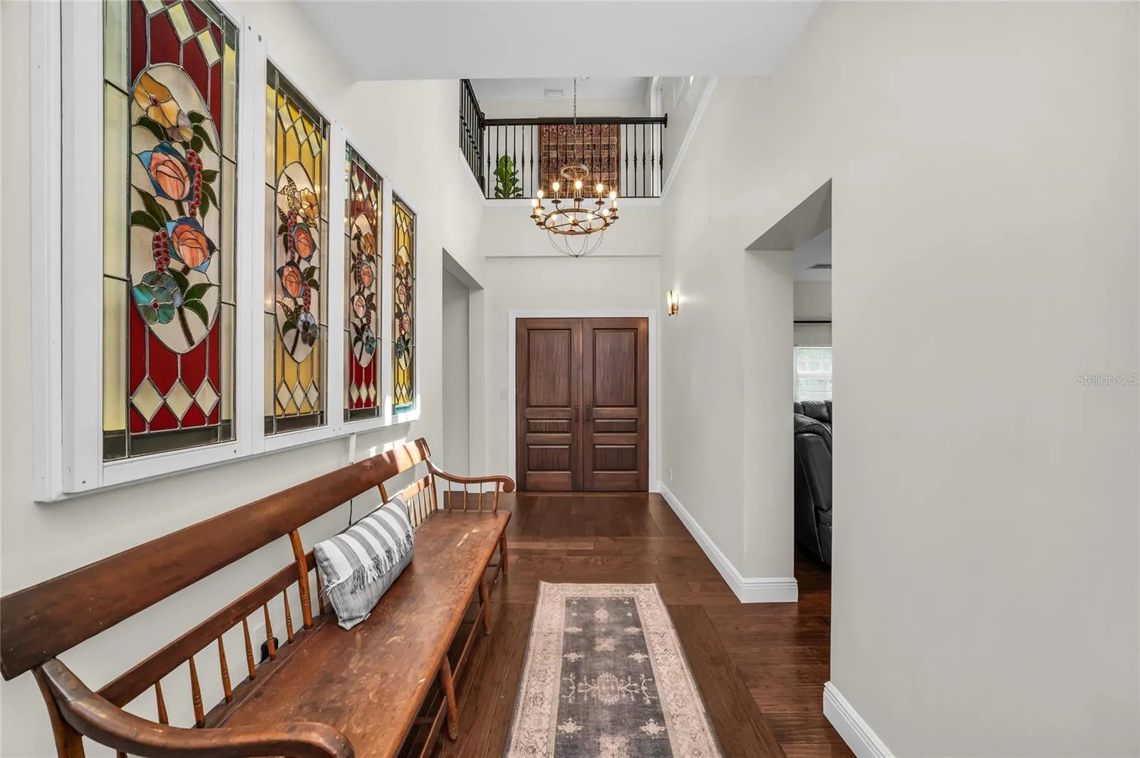 Grand, light-filled two-story entryway with wall space perfect for showcasing your favorite art pieces. The beautiful upper-level overlook enhances the architectural drama, making it a a truly memorable welcome for guests.