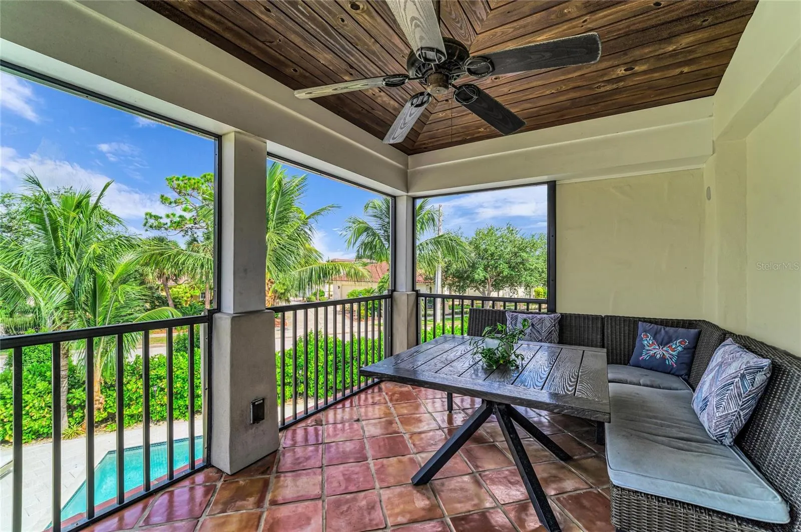 Screened porch in the owner's suite that overlooks the pool.