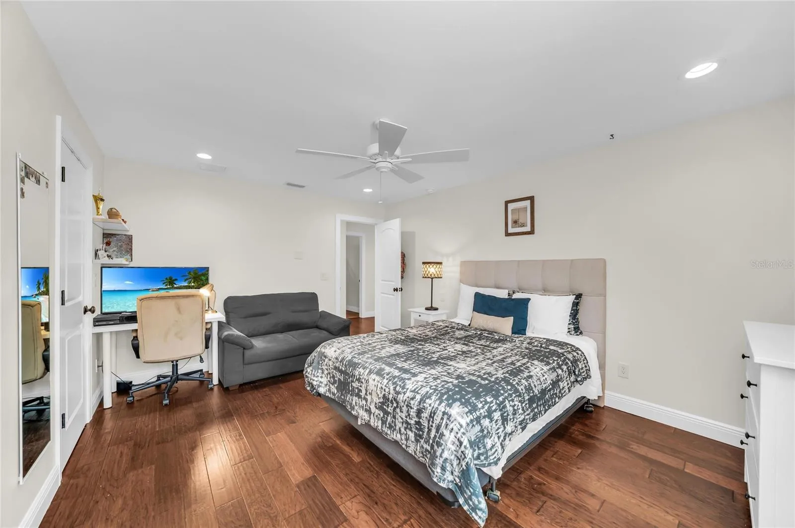 Spacious second level bedroom with an ensuite bath, walk-in closet and view of the pool.