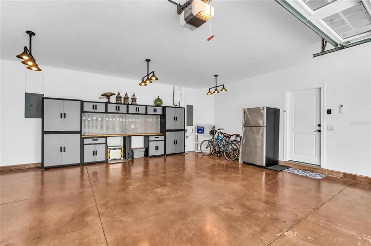 Spacious garage with epoxy floor and custom workbench