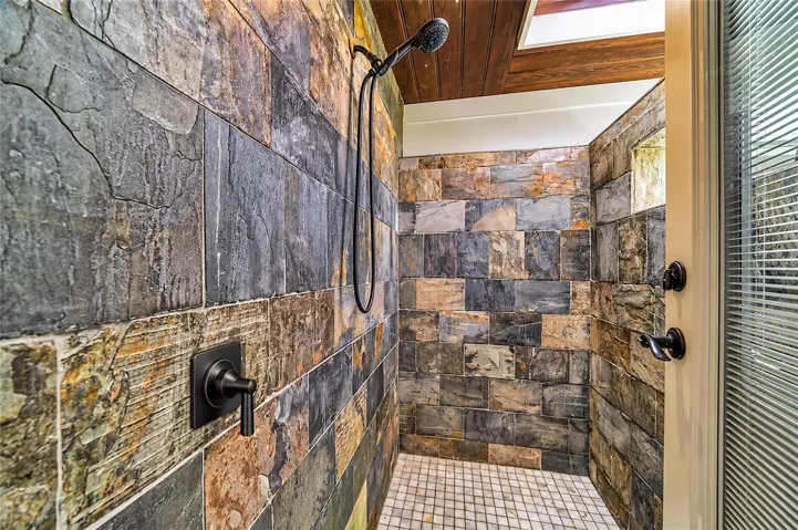 Outdoor shower, accessed from within the owner's ensuite bathroom brings a touch of resort-style living to the home.