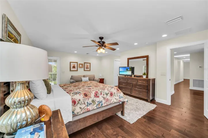 PRIVATE OWNER'S RETREAT featuring a screened porch overlooking the pool and an ensuite bathroom with tub and shower. An additional outdoor shower, accessed from within the full bath brings a touch of resort-style living to the home.
