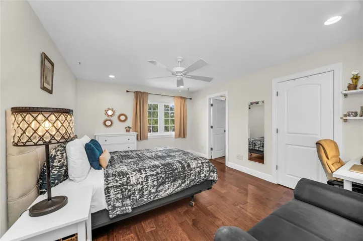 Spacious second level bedroom with an ensuite bath, walk-in closet and view of the pool.