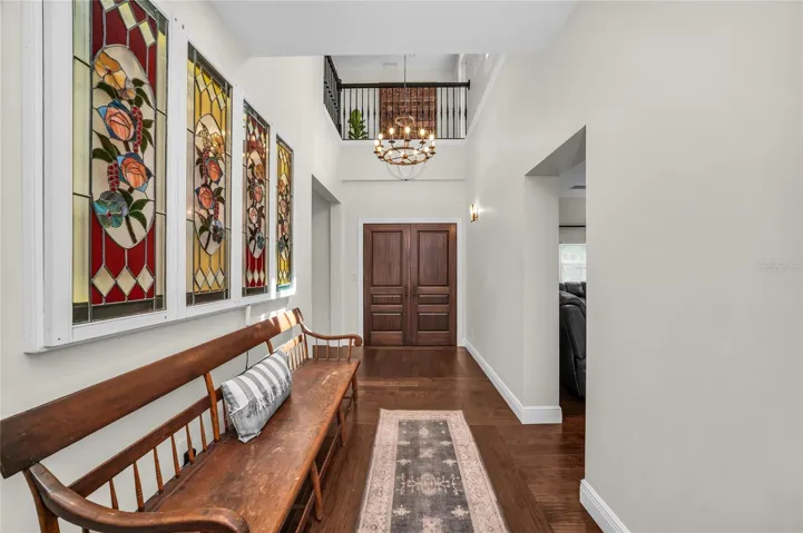 Grand, light-filled two-story entryway with wall space perfect for showcasing your favorite art pieces. The beautiful upper-level overlook enhances the architectural drama, making it a a truly memorable welcome for guests.