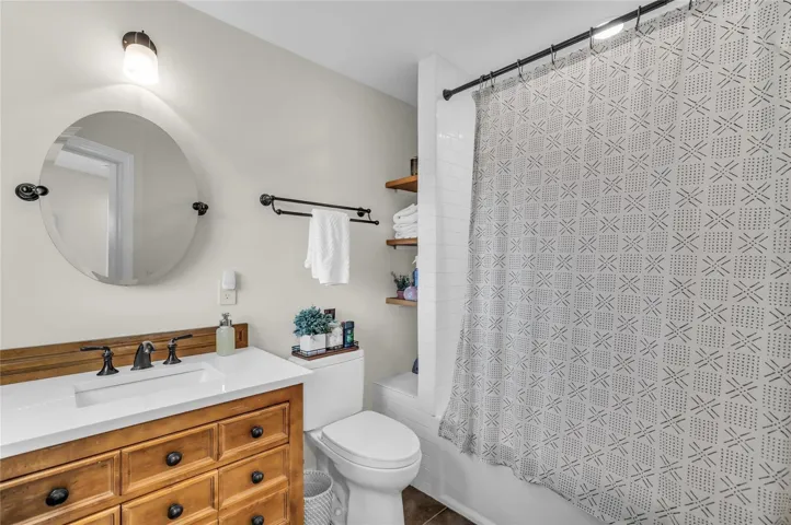 Second level apartment full bathroom with tub/shower and single vanity.