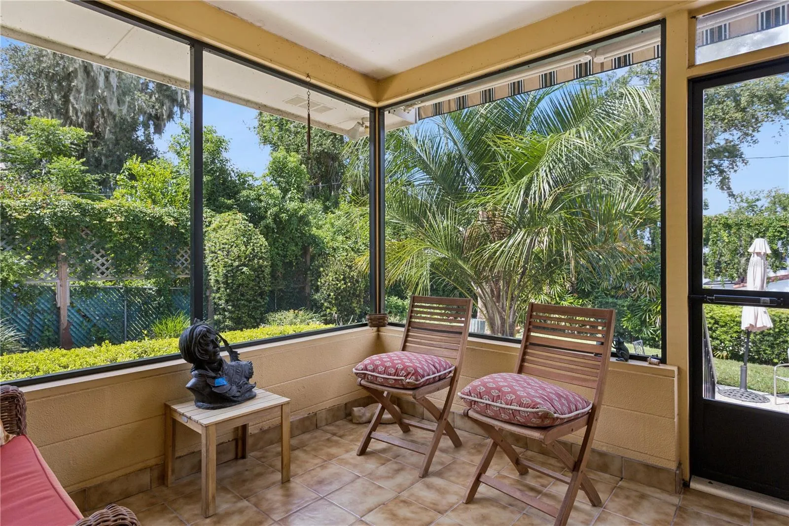 Florida room off the family room with new screens and a sunsetter awning