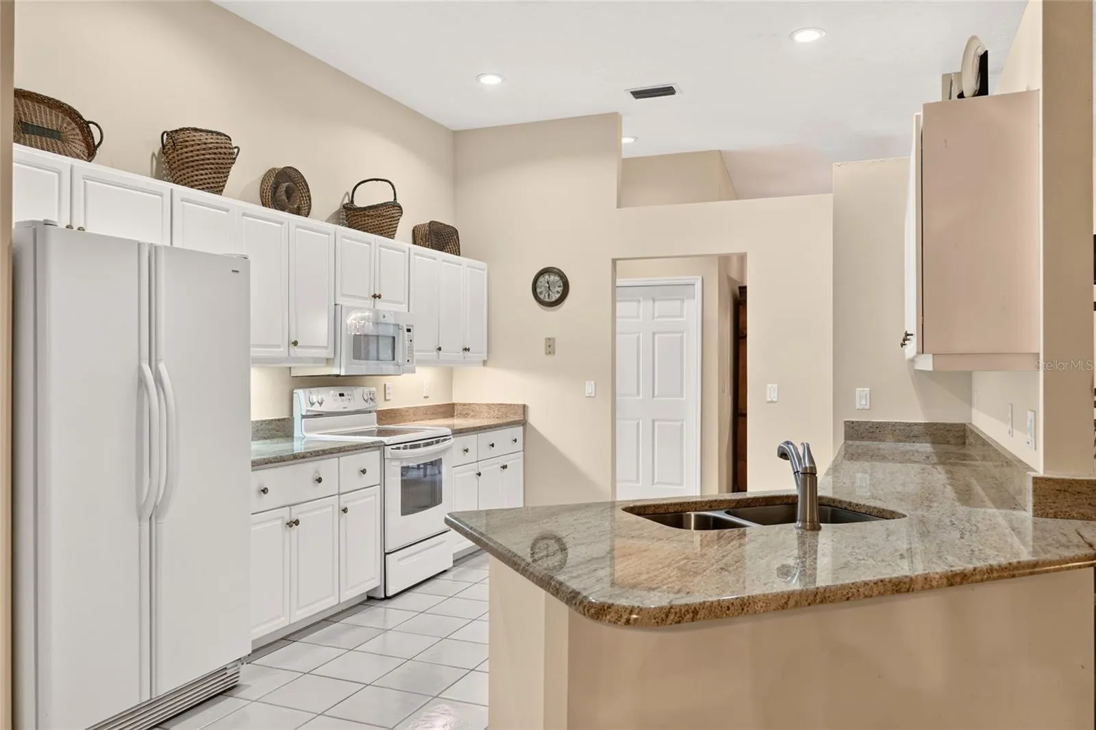 Large kitchen with granite countertops.