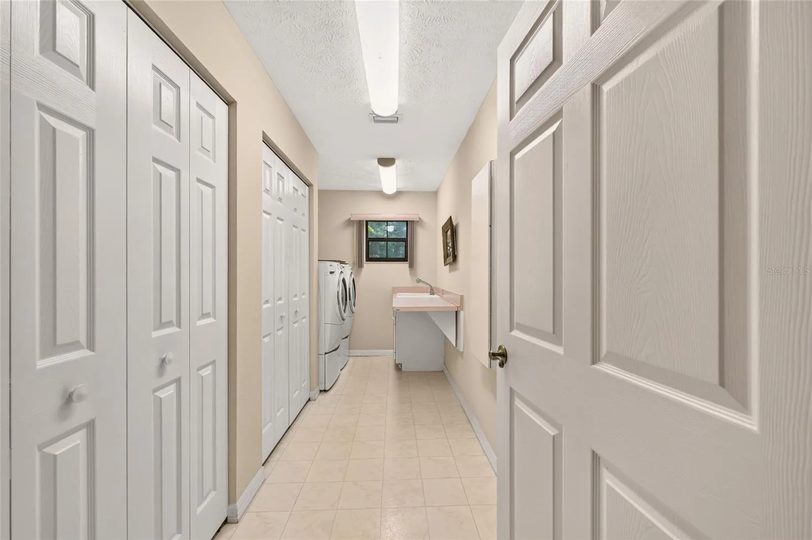 Inside laundry room with ample storage.