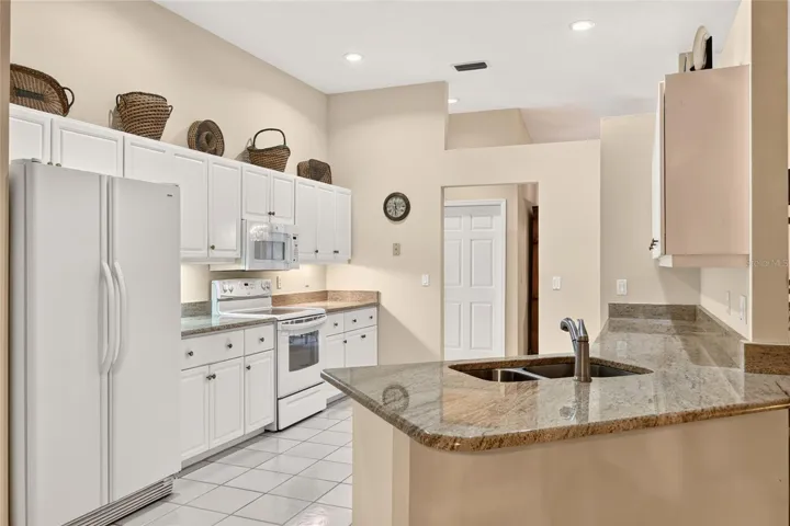 Large kitchen with granite countertops.